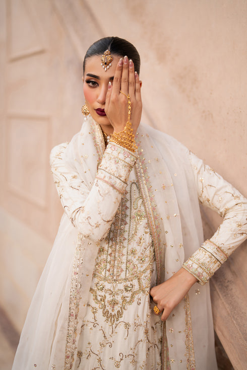 NAQSHI Gul-e-Rohma angled shot – elegant silhouette, embroidery flow on hem, bordered sleeves and culottes